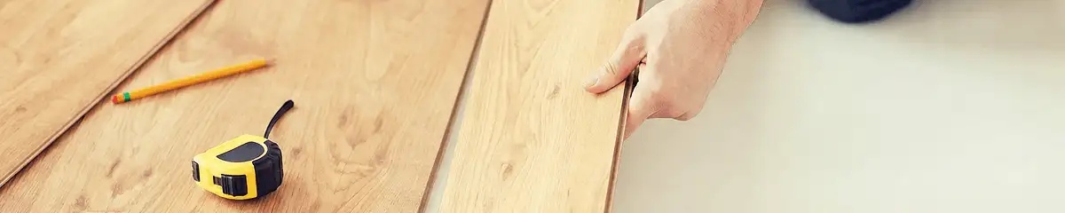 A professional installing wood flooring in Bellevue, WA