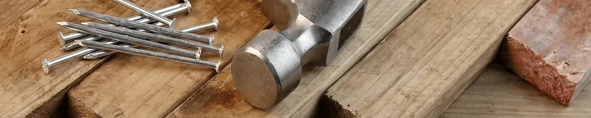 Hammer and nails on hardwood flooring boards in Bellevue, WA