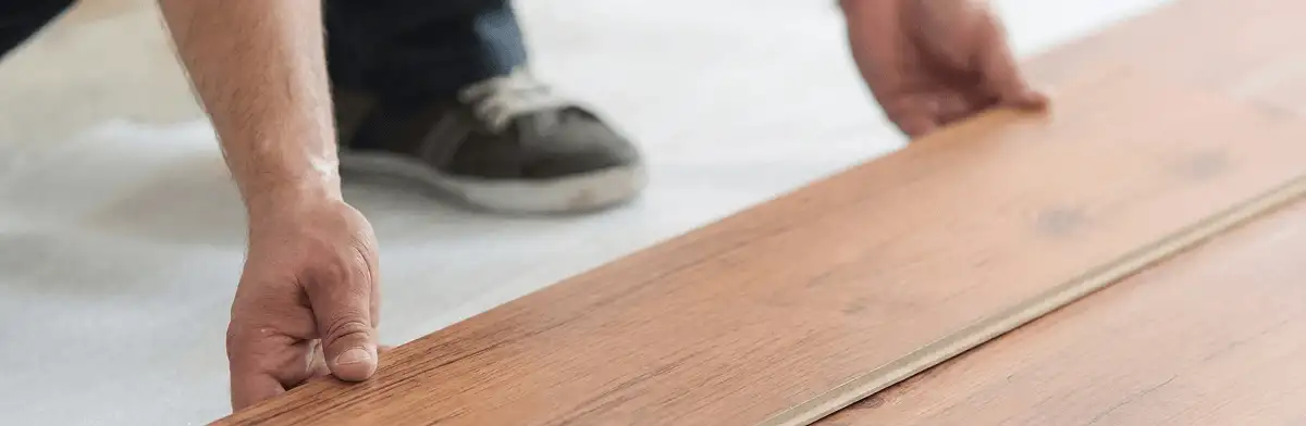 A professional installing laminate flooring in Bellevue, WA