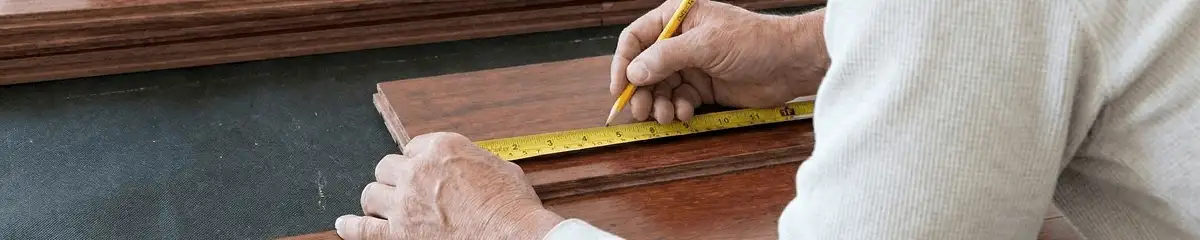 A professional installing wood flooring in Bellevue, WA